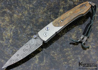 William Henry Custom Knife A.G. Russell Exclusive Mammoth Bark, Stippled Titanium and Mike Norris Raindrop Damascus with Sapphires Button Lock